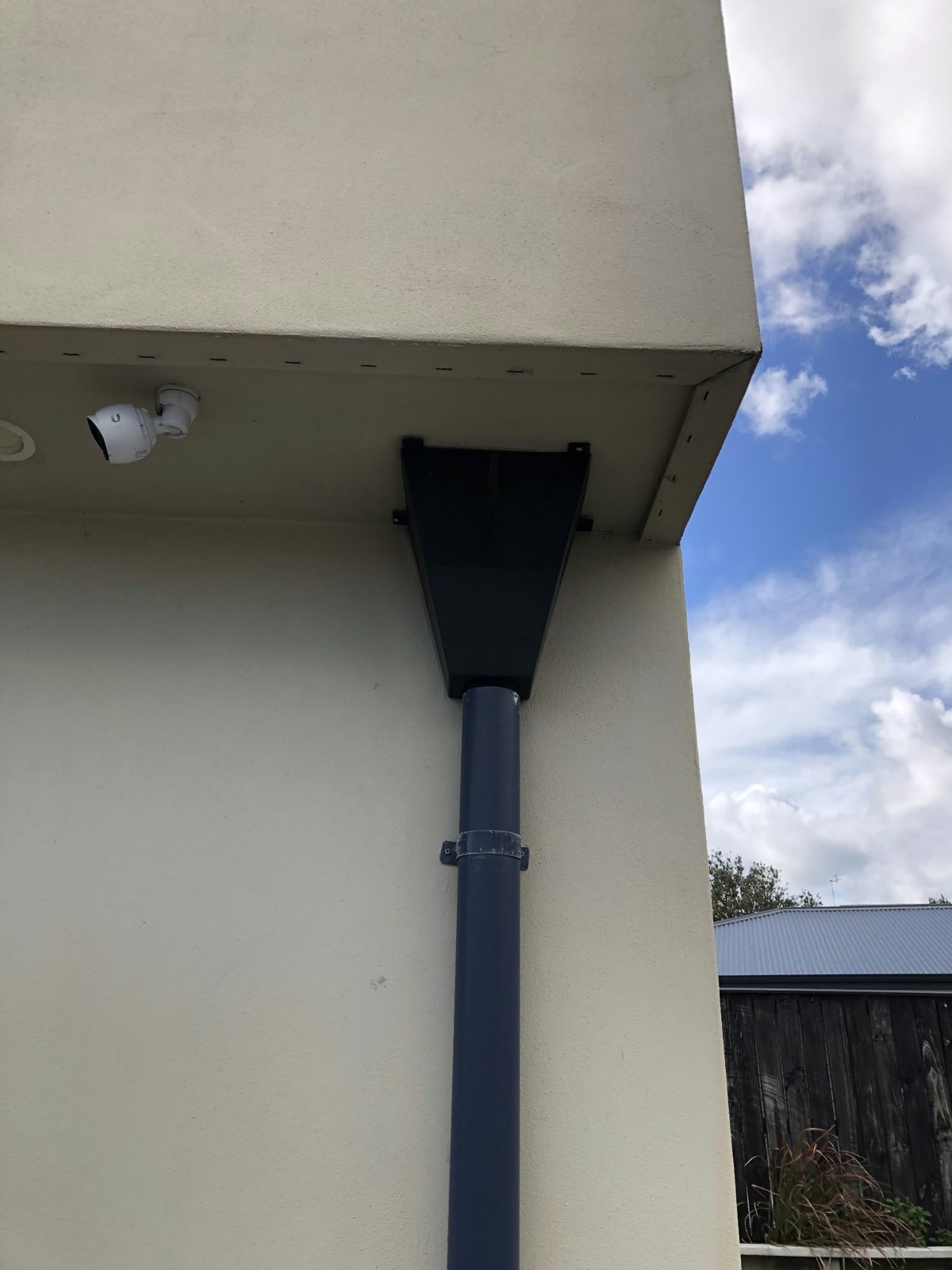 Completed funnel mounted beneath the eaves and joined to the existing downpipe.