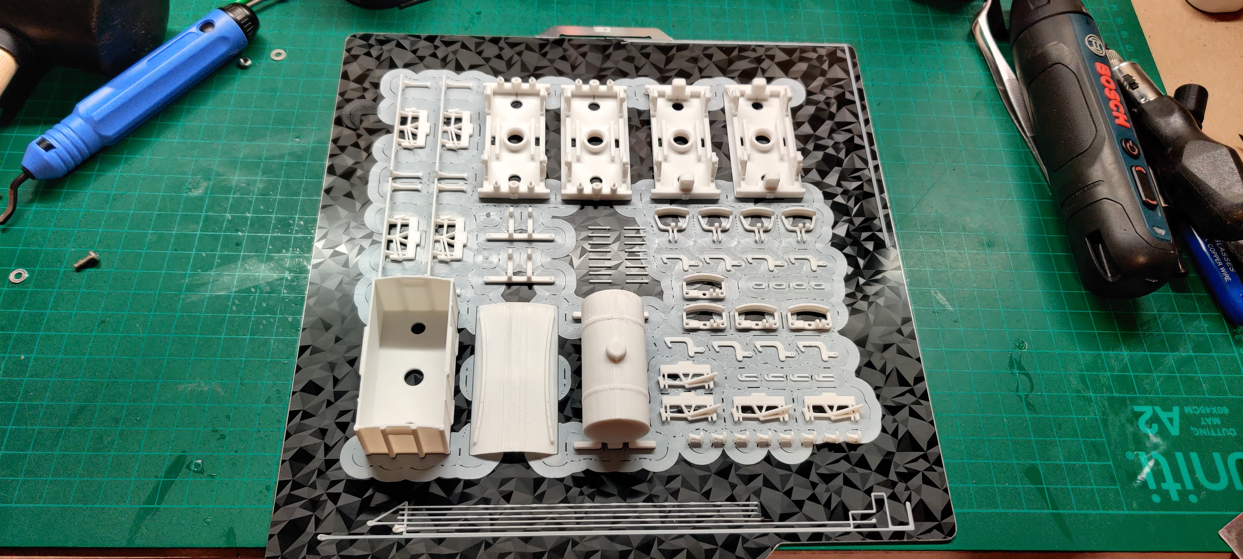 Miniature train set components prepared for assembly.