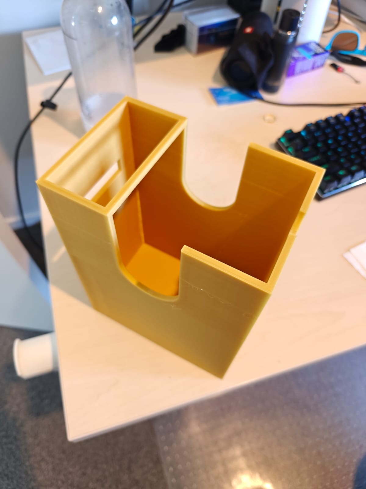 Three wise monkeys printed in yellow filament.