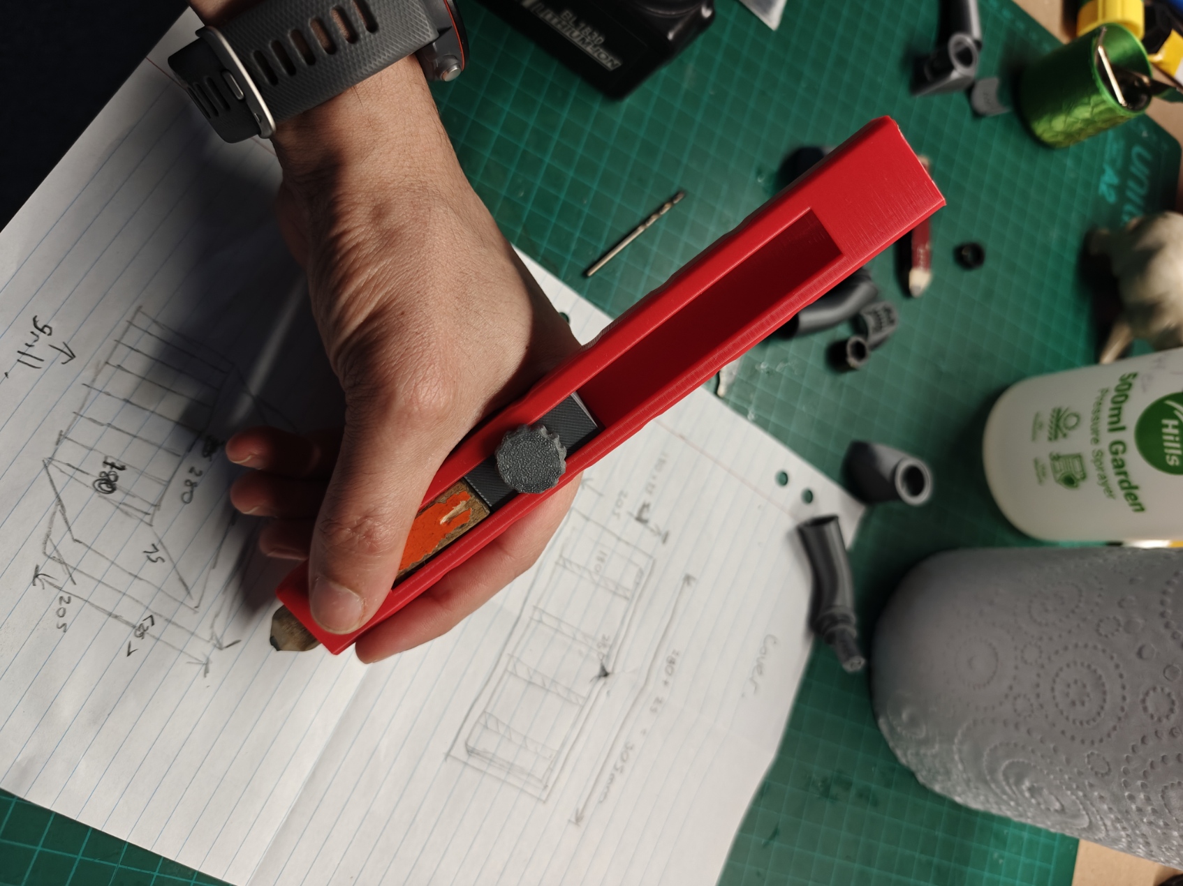 Alternative view of a hand gripping the builder pencil holder.
