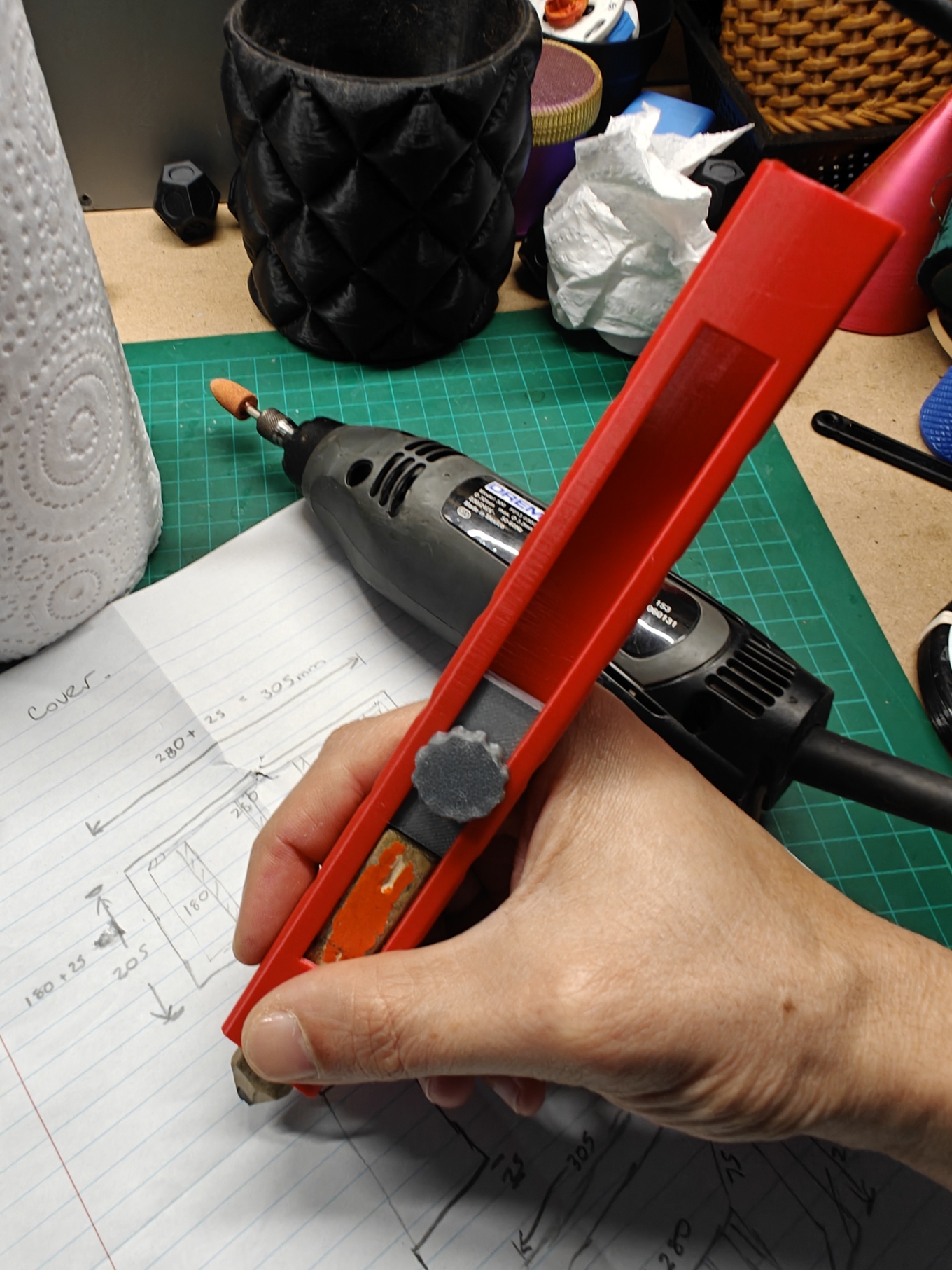 Builder pencil holder held in the hand, with the pencil tip exposed for marking.