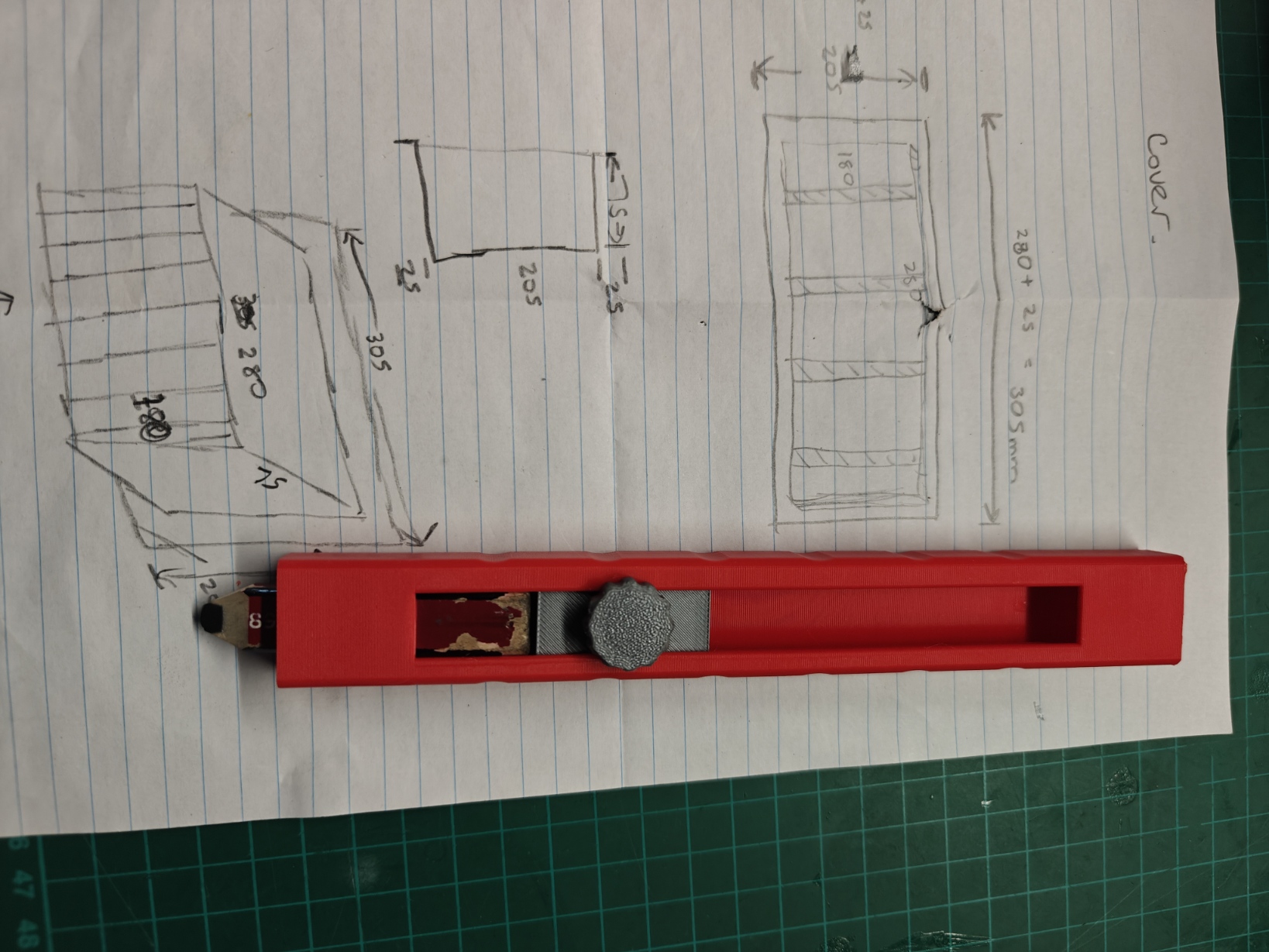 Top view of the red builder pencil holder and grey adjustment knob.